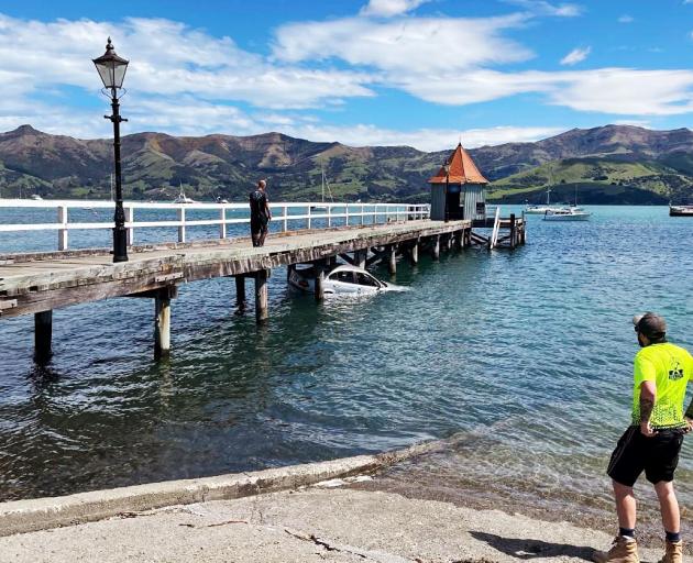 The car floats to a Daly's wharf at Akaroa after the driver was rescued. Photo: Supplied