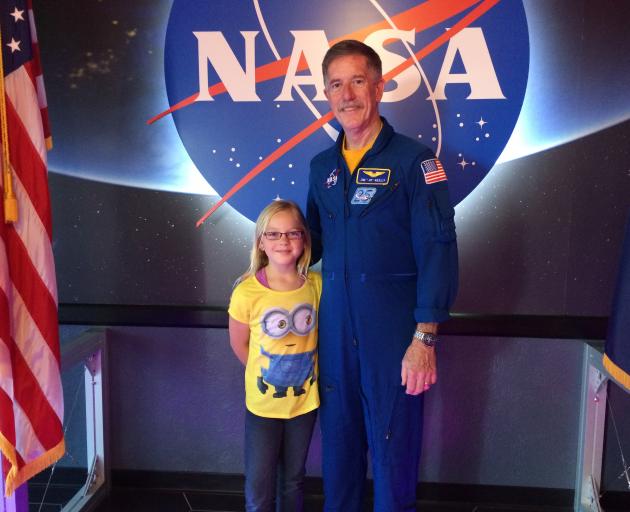 Amber Collishaw when she was nine with NASA astronaut, James F Reilly ll. Photo: Supplied