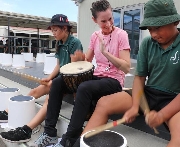 Year 5 pupils Phoenix and Roman with CSO principal percussion Roanna Funcke. Photo: John Cosgrove