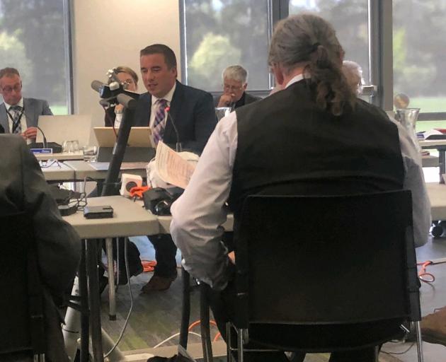 Cr Mark Alexander (back to camera) went to the meeting on his own e-scooter, but voted against...