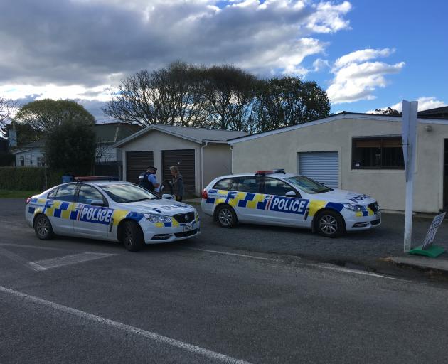 Police at the Kakanui Store on High St this afternoon. Photo: Daniel Birchfield