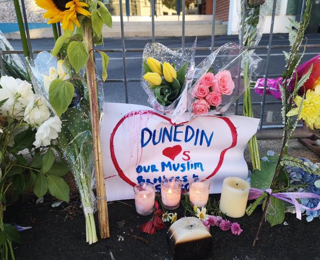 Flowers and candles were left outside Dunedin's Al Huda  mosque this morning. Photo: Vaughan Elder