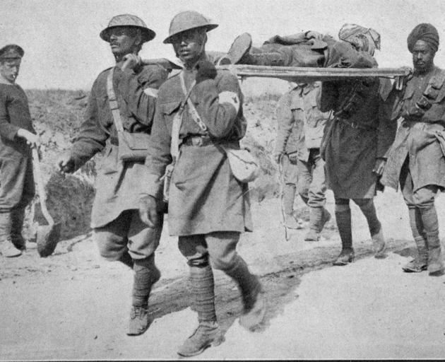 Four Indian soldiers carry one of their wounded officers in France. - Otago Witness, 6.12.1916. 