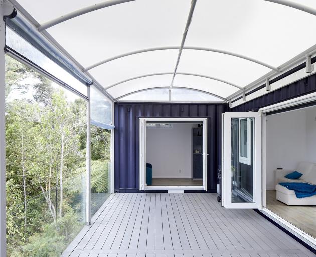 The covered deck allows the two containers to operate as a single living space. 