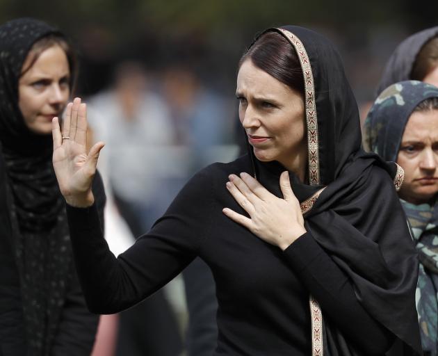 Wearing a hijab in support of the Muslim community, Jacinda Ardern acknowledges the crowd...