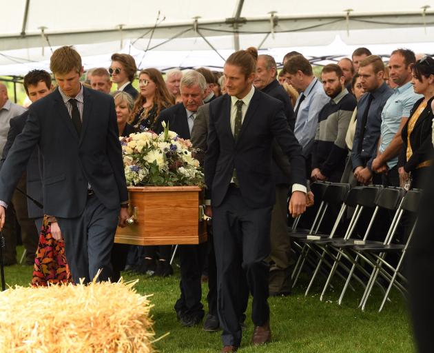 The casket with Nadine and her son Angus Tomlinson is carried to their funeral service. Photo:...