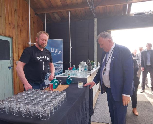 Bluff Distillery Company part owner Chris Fraser offers Shane Jones a gin during his tour of the...