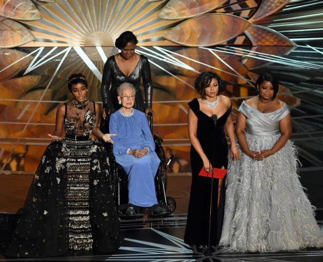 NASA mathematician Katherine Johnson (seated) appears onstage with (L-R at front) actors Janelle Monae, Taraji P. Henson and Octavia Spencer speak onstage during the 89th Annual Academy Awards. Photo: Getty Images 