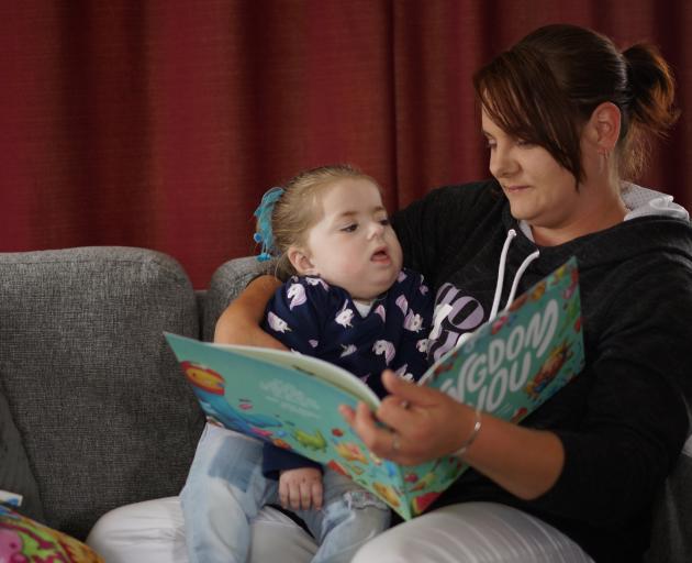 Sascha Abey reads to her daughter Keira Mcmurdo. PHOTO: SUPPLIED

