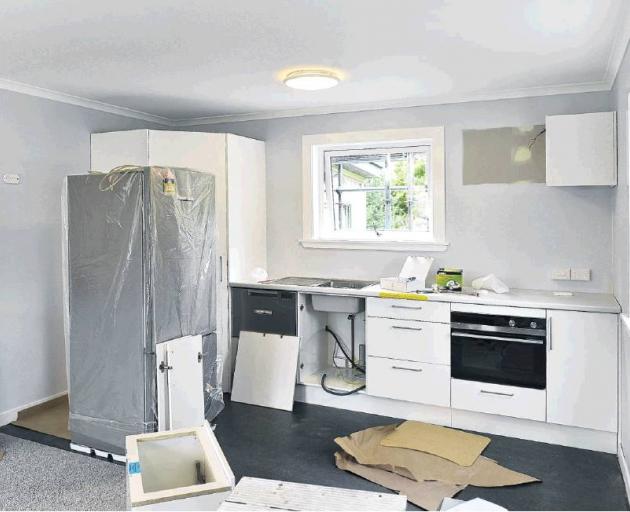 The kitchen takes shape in the open-plan kitchen-living area, which opens onto a deck.