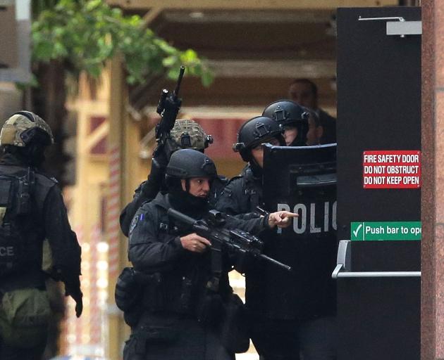 Armed police at the Lindt Cafe in Sydney. Two people were killed during the siege in December...