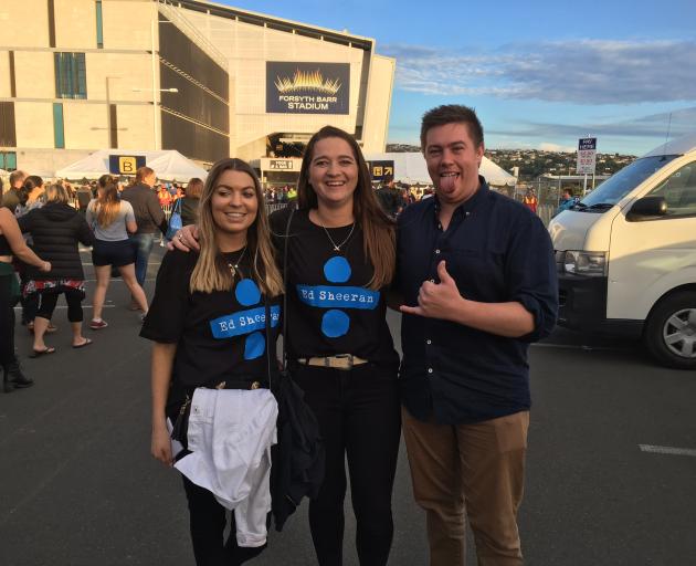 Fans pose for a photo outside the stadium. Photo: Peter McIntosh