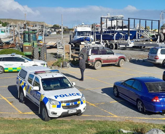 Kaikoura Mayor Craig Mackle speaks on the phone near the South Bay slipway where emergency...