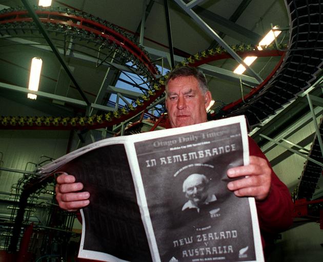 Former All Black locking maestro Colin Meads reads one of the first copies of the Otago Daily...