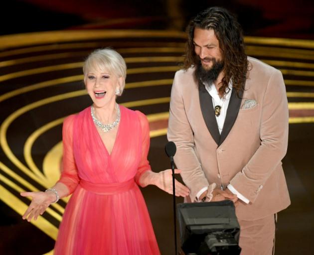 Helen Mirren and co-presenter Jason Momoa both wore pink at the Oscars. Photo: Getty Images 
