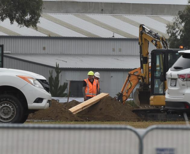 City Care workers prepare graves at a cemetery in Christchurch for the victims of the mosque...