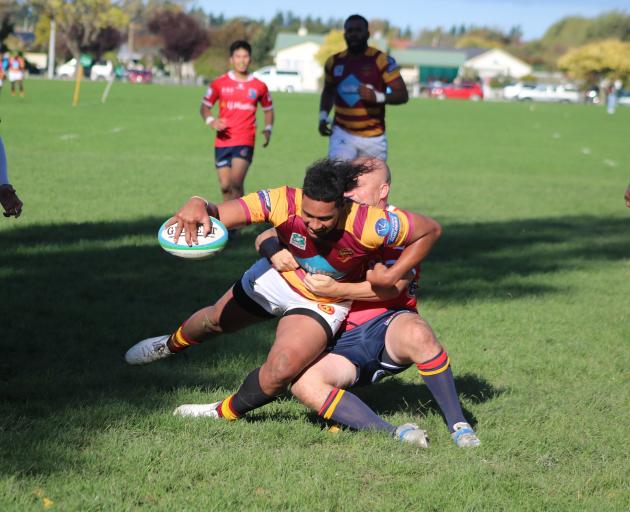 Kurow’s Tyler Burgess (left) holds up Athletic Marist’s Paea Fifita as he attempts to score...