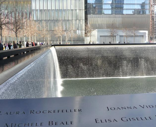 Names of those who died in the terror attacks line the memorial pools near One World Trade Centre and giant walls of water pour down the sides and into a black hole in the centre to be recycled. PHOTO: HELEN SPEIRS