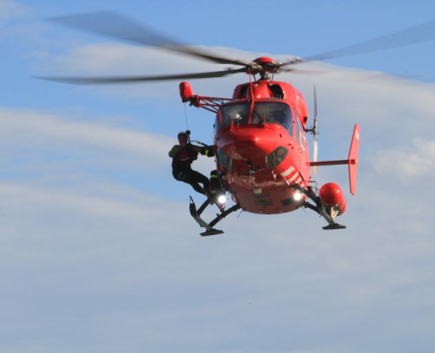 An Otago Rescue Helicopter crew member is hoisted back on board after leaving the water during a...