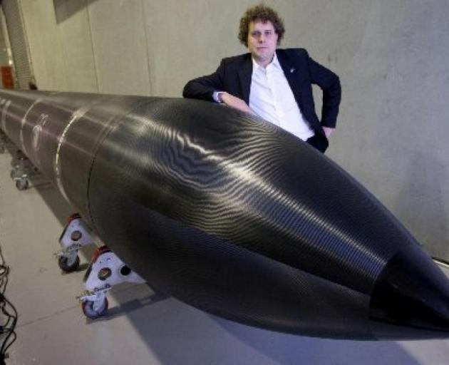 Peter Beck with his Electron rocket. Photo NZ Herald