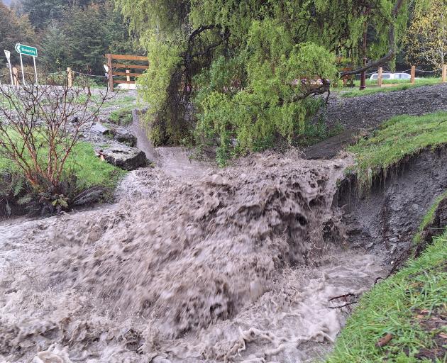 A swollen One Mile Ck appears from a culvert under the One Mile roundabout in Queenstown. Photo:...
