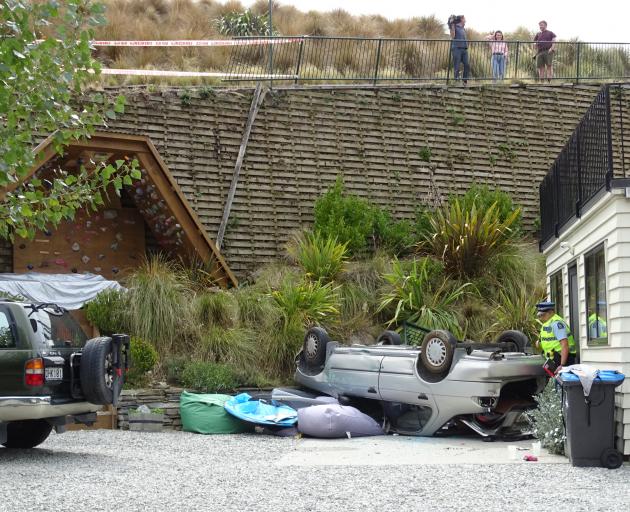 This vehicle crashed through a fence and fell almost 7m, landing on its roof centimetres away...