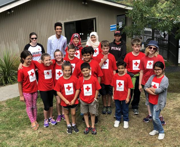  Mr Munassar (blue shirt) poses with some of his Red Cross Young Humanitarians. PHOTO: SUPPLIED