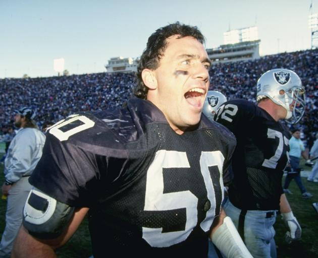 Ellison celebrates in 1990 when the Los Angeles Raiders beat the San Diego Chargers. Photo: Getty...