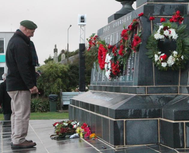 RSA member Alan Frazier pays respect and places his poppy at the Invercargill’s cenotaph. PHOTO:...