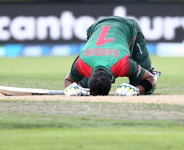 Sabbir Rahman Roman celebrates his century at the University Oval earlier today. Photo: Getty...