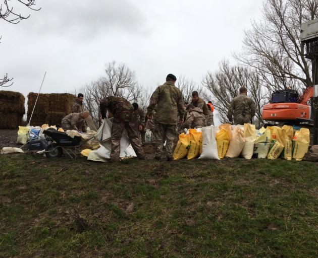 Members of the Defence Force help with sandbagging on Saturday. Photo: ORC