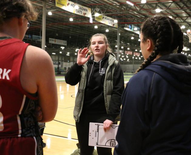 Erica Stedman gives a halftime talk to the Logan Park High School senior girls basketball team.