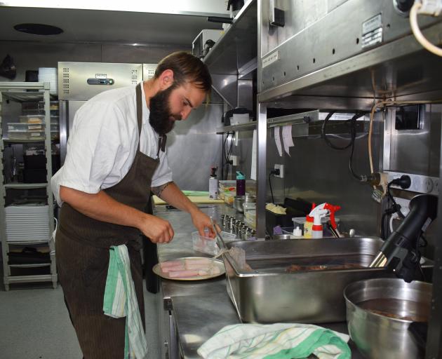 Ode chef Lucas Parkinson prepares a fish dish in the test kitchen. Photos: Kerrie Waterworth.