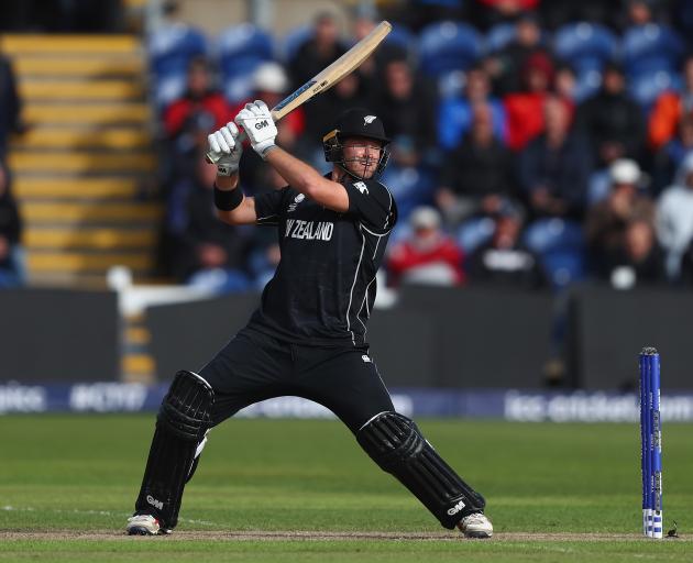 New Zealand batsman Corey Anderson smashes the ball through the offside during the Champions...