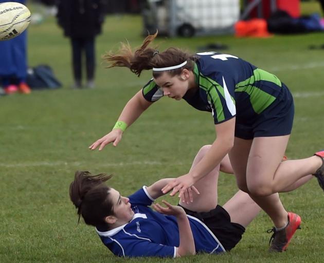 Columba College's Niamh Paterson loses the ball forward in the tackle of Central Southland...