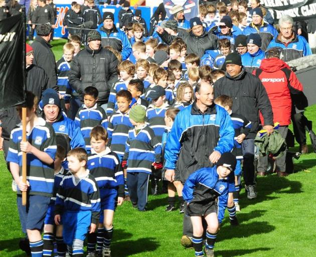 Kaikorai take part in a junior rugby marchpast ahead of the Otago vs Canterbury game on Saturday.