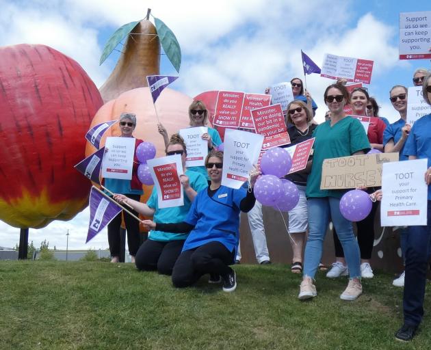 Queenstown and Cromwell nurses join forces at the Big Fruit sculpture yesterday to protest against the lack of pay parity for primary healthcare nurses. Photo: Simon Henderson