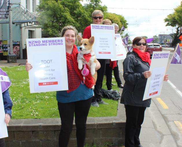 Protesting in Wachner Pl, in Invercargill, yesterday are (from left) Invercargill Medical Centre (IMC) nurses Charlotte Pearce (with dog Pippin) and Jill Tanner and IMC administrator Gabrielle Bulman. Photo: Karen Pasco