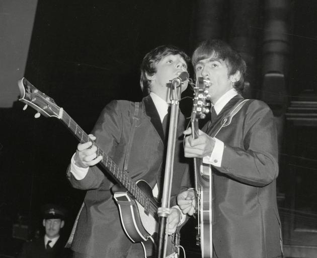 Paul McCartney (left) and George Harrison perform on stage  in Dunedin 57 years ago.