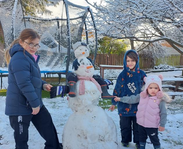 From left: Katelyn Hughes (12), Kahu Houpapa (5) and Nevaeh Houpapa (2) made a snowman in...