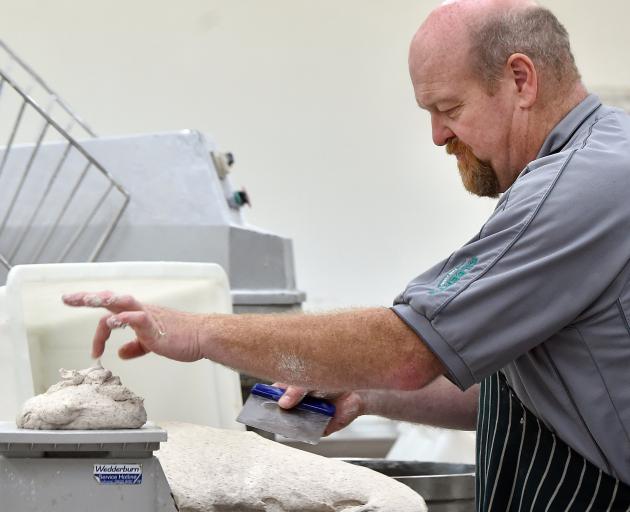Kevin Gilbert weighs the dough. PHOTO: PETER MCINTOSH