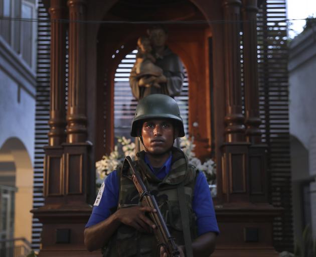 A Sri Lankan soldier stands guard at the damaged St. Anthony's Church in Colombo. Photo: AP
