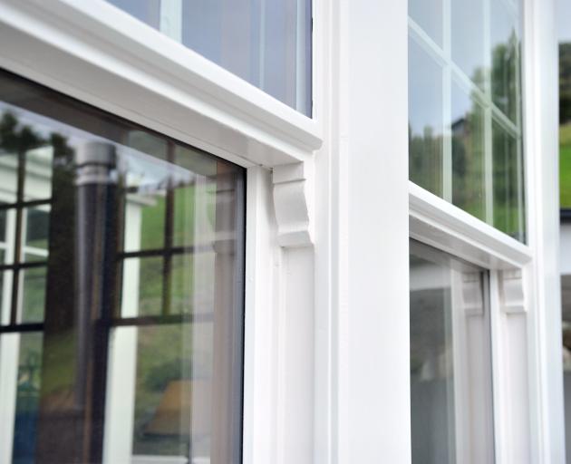 The top sections of the living room sash windows have an exterior double-
...