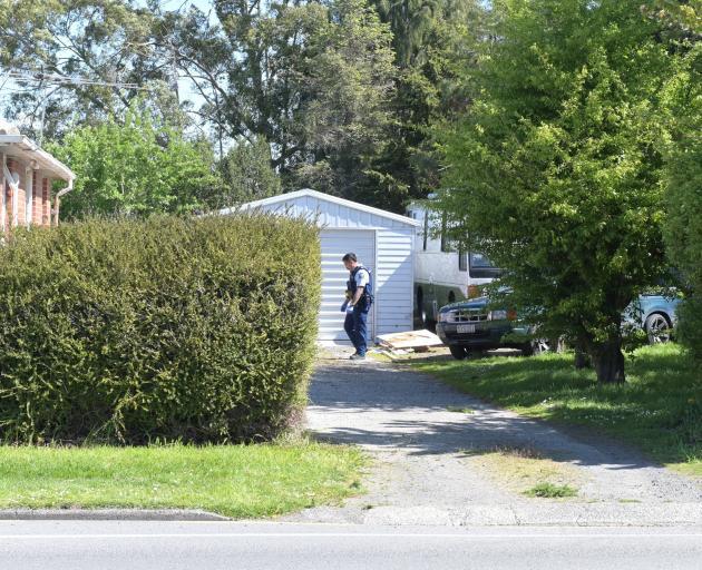 Police canvass the Momona property where Grant Jopson was fatally stabbed. Photo: Linda Robertson