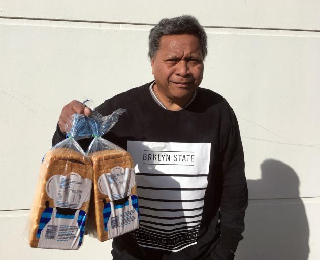 Hotesi Maito, of  Dunedin, buys loaves of toast bread on Friday to feed his sons. PHOTO: SHAWN...