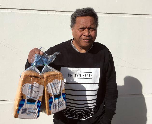 Hotesi Maito, of Dunedin, buys loaves of toast bread on Friday to feed his sons. PHOTO: SHAWN...