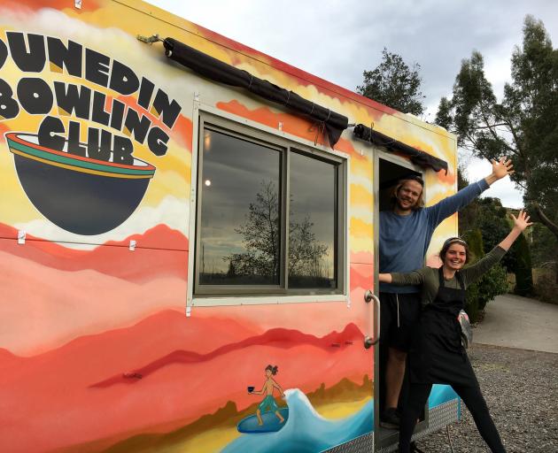 Community chow . . . Dunedin Bowling Club operators Jackie Bannon (left) and Liam Arthur bring a...