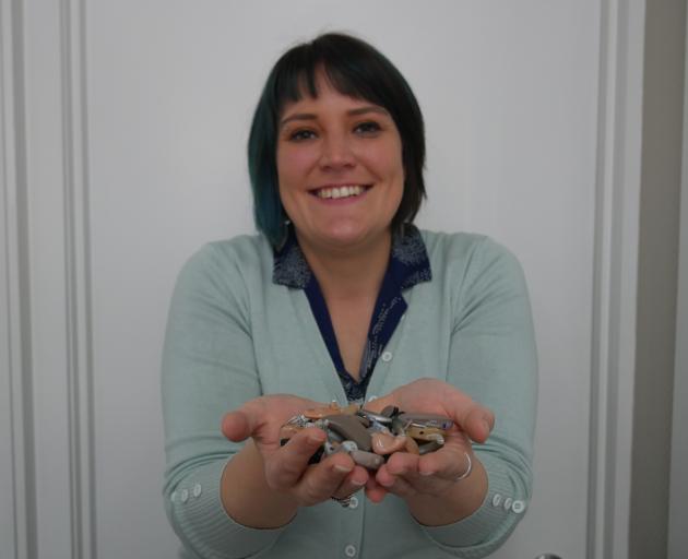 Hearing Support Otago field officer Lisa Jankowska shows off different kinds of hearing aids...