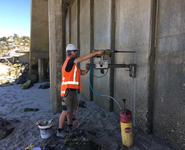 Cut and Core Concrete Cutting owner and operator Craig Cayford, of Dunedin, cores holes in the sea wall at the Esplanade at St Clair on Tuesday. PHOTOS: SHAWN MCAVINUE