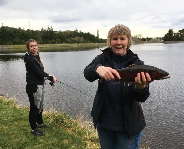 Workmates Corrina Beel (left) and Jo Macbeth, both of Dunedin, fish for rainbow trout as part  of...